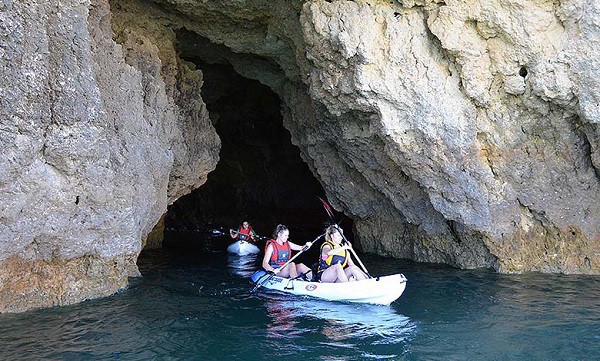 Kayaks emerging from one of Albufeira's caves