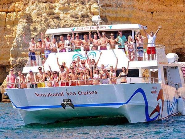 Lots of happy guests onboard catamaran Ophelia during the BBQ and caves cruise