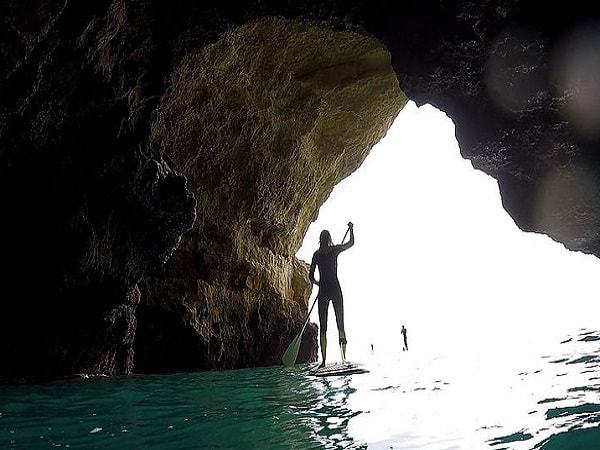 SUP inside the caves in Benagil near the exit with light