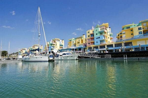 Albufeira marina with sailing boat and colourfull