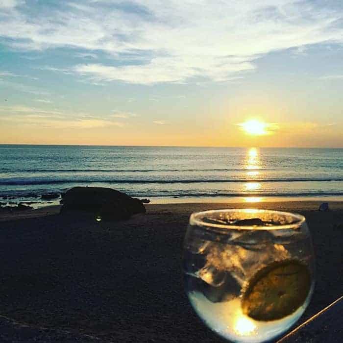 Cocktail glass at Galé beach at sunset
