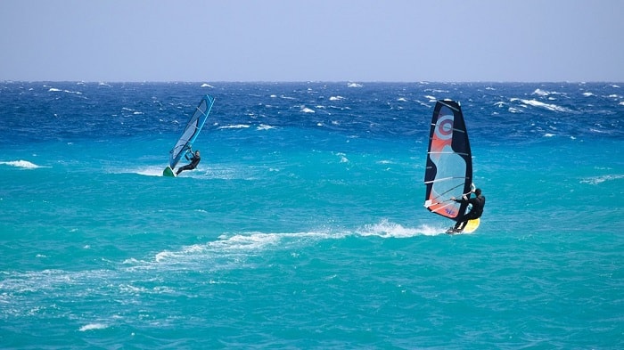 e men Windsurfing with beutiful bue sea in the Algarve